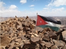 Jordan Flag on Mountain Peak - Wadi Rum Desert Tours